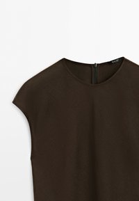 Dark brown short-sleeve blouse with round neckline and back zipper closure, laid flat against a light background.