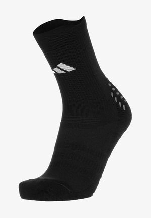 Calzino sportivo nero con texture a coste, lunghezza fino al polpaccio e logo bianco. Presenta dei punti antiscivolo in silicone grigio vicino al tallone per una migliore aderenza.