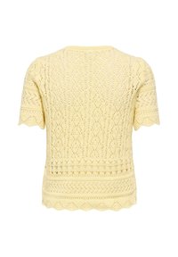 Haut jaune à manches courtes en maille avec des motifs en dentelle complexes et un ourlet festonné, vu de dos.