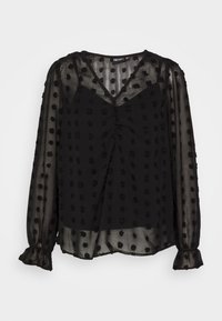 Blusa nera trasparente con texture a pois rotondi, scollatura a V, fronte arricciato e polsini elasticizzati. Maniche lunghe con orli arricciati.