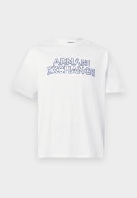 Λευκό κοντομάνικο μπλουζάκι με τη φράση "ARMANI EXCHANGE" σε έντονα μπλε γράμματα με περίγραμμα στο στήθος.