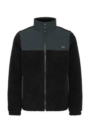Fleecejacke mit durchgehendem Reißverschluss, hohem Kragen, schwarzem strukturiertem Körper und glattem dunkelgrauem Bereich an der Oberseite. Auffälliges Logo auf der Brust.