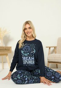 Nawigacyjny zestaw odzieży domowej składający się z bluzy z długim rękawem z napisem "DREAM EXPLORER" i kosmicznymi grafikami, w komplecie z pasującymi legginsami z nadrukiem.