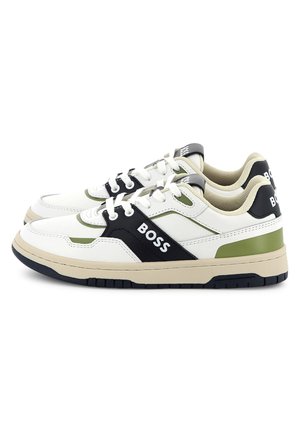 White athletic shoes with black and green accents. Features a textured upper, padded collar, and a thick, rubber sole with traction.