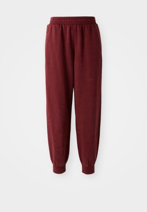 Burgunderfargede sweatpants med elastisk midjebånd og elastiske mansjetter. Glatt tekstur og avslappet passform. Ingen synlige mønstre eller maskinvare detaljer.