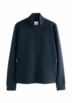 Jūras spēku zip-up jaka, izgatavota no teksturēta auduma, ar stāvošu apkakli, divām priekšējām kabatām ar rāvējslēdzējiem un ribotām aprocēm un apakšmalu.