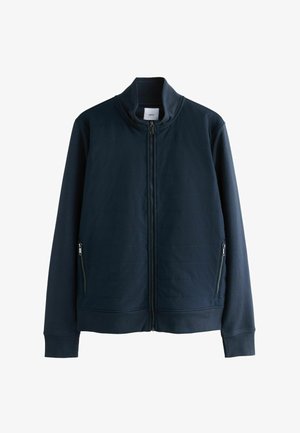 Jūras spēku zip-up jaka, izgatavota no teksturēta auduma, ar stāvošu apkakli, divām priekšējām kabatām ar rāvējslēdzējiem un ribotām aprocēm un apakšmalu.