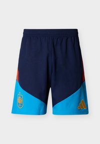 Navy blue sports shorts with sky blue lower panels, red and yellow side stripes, Spain soccer team crest on left, and gold Adidas logo on right.