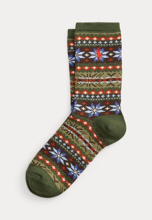 Paire de chaussettes vertes avec des motifs géométriques et floraux rouges, bleus et blancs et un petit logo rouge brodé près du haut.
