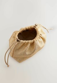 Gold drawstring bag made of textured metallic material, featuring a cinched top, soft interior lining, and a unique, rounded shape.
