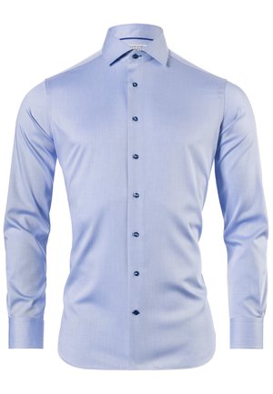 Light blue long-sleeve shirt made of smooth fabric with a spread collar, featuring dark blue buttons and a rounded hem.