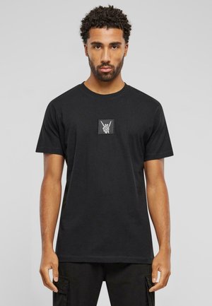 Black cotton t-shirt featuring a square chest patch with a graphic of a hand making a peace sign. Regular fit with short sleeves.