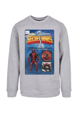 Gray sweatshirt featuring a printed graphic of a red Deadpool action figure packaged in a vintage card with a shield and accessories.