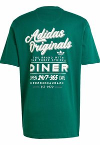 Green cotton t-shirt featuring bold white text with "Adidas Originals" and diner-themed graphics, short sleeves, and a round neckline.