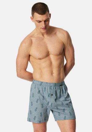 Grau Baumwollshorts mit einem durchgehenden Ananas-Print in Dunkelblau. Elastischer Bund mit Knopfverschluss, legerer Schnitt.