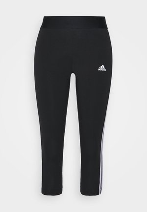 Czarne legginsy slim-fit Adidas z białym detalem z trzema paskami po bokach i logo Adidas na górnej części uda.