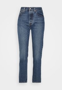 Modré džínové kalhoty s vysokým pasem, rovnými nohavicemi a jemným vyblednutím. Obsahují přední a zadní kapsy a zapínání na knoflík. Klasický design.