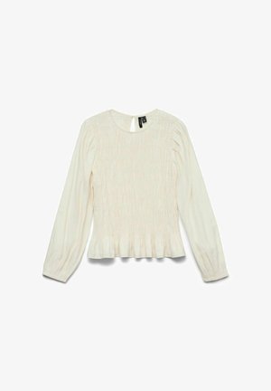 Blusa color crema con mangas largas, textura fruncida, escote redondo y borde con volantes. Detalle de abertura en la parte trasera.