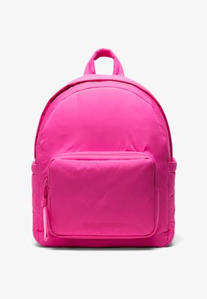 Pink nylon backpack with a rounded shape, a front zippered pocket, and a top handle. Features a smooth texture and prominent brand logo.