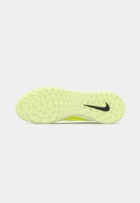 Suela de zapato Nike verde claro con patrón de agarre texturizado y logotipo de swoosh negro sobre un fondo blanco.