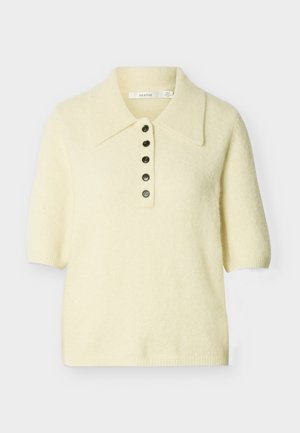 Cream-colored short-sleeve knit top with wide collar and five dark buttons down the front center.