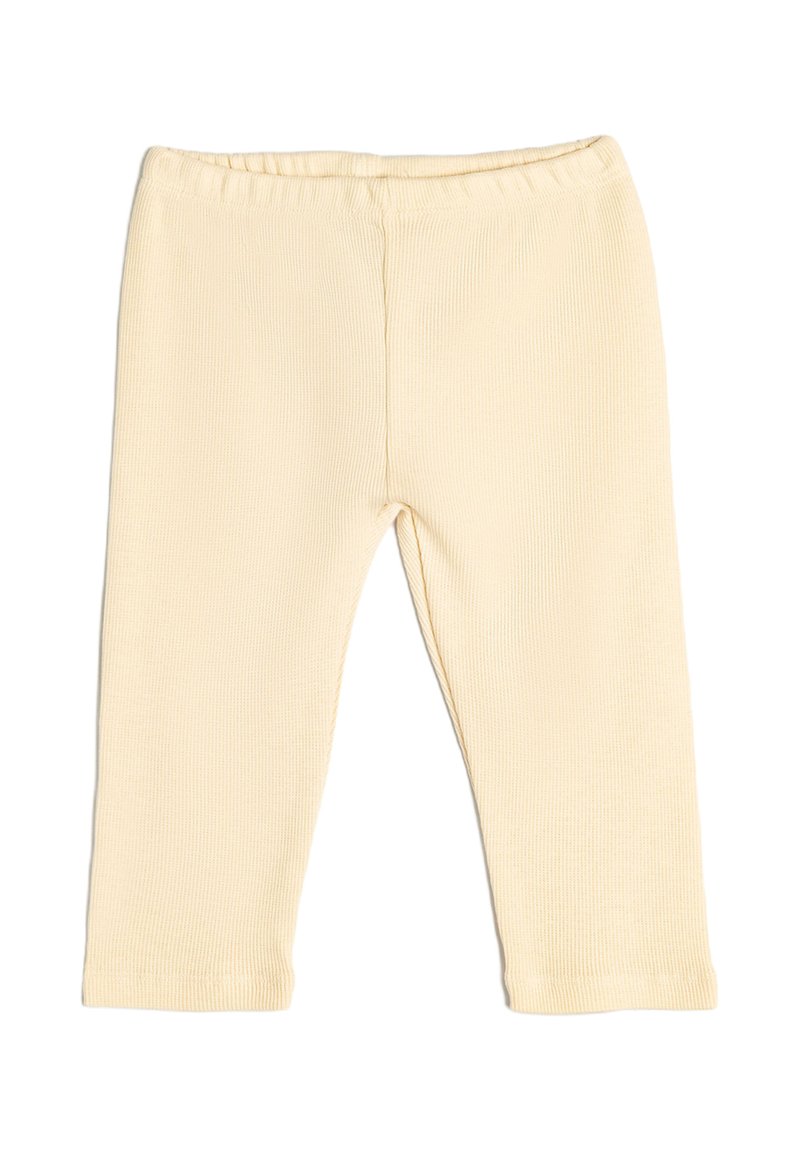 Leggings de canalé de color beige claro con una cinturilla elástica, diseño ajustado y sin herrajes ni acentos visibles. Textura suave y corte hasta los tobillos.