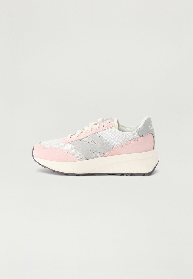 Sneakers with a pink and white upper, gray accents, and textured suede detail. Features a thick white midsole and patterned rubber outsole.