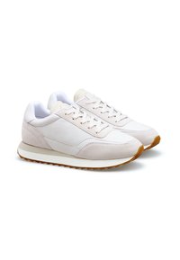 Light pink sneakers with a mix of leather and suede materials, featuring a white sole and textured rubber outsole for grip.