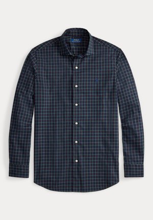 Mörkblå rutig skjorta med långa ärmar, knäppning med krage, vita knappar och liten logotyp. Har ett grönt och vinrött rutmönster.