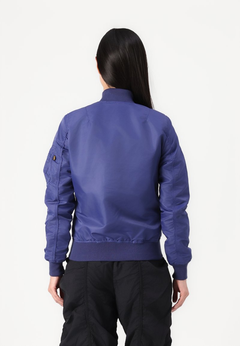 Purple bomber jacket with a ribbed cuff and hem, featuring a smooth, glossy texture and side pockets, shown from the back.