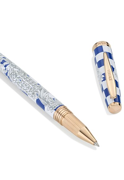 Niebieski i biały długopis w wzory z złotymi akcentami, posiadający teksturowany uchwyt oraz zakręcaną końcówkę z ozdobnym klipem.