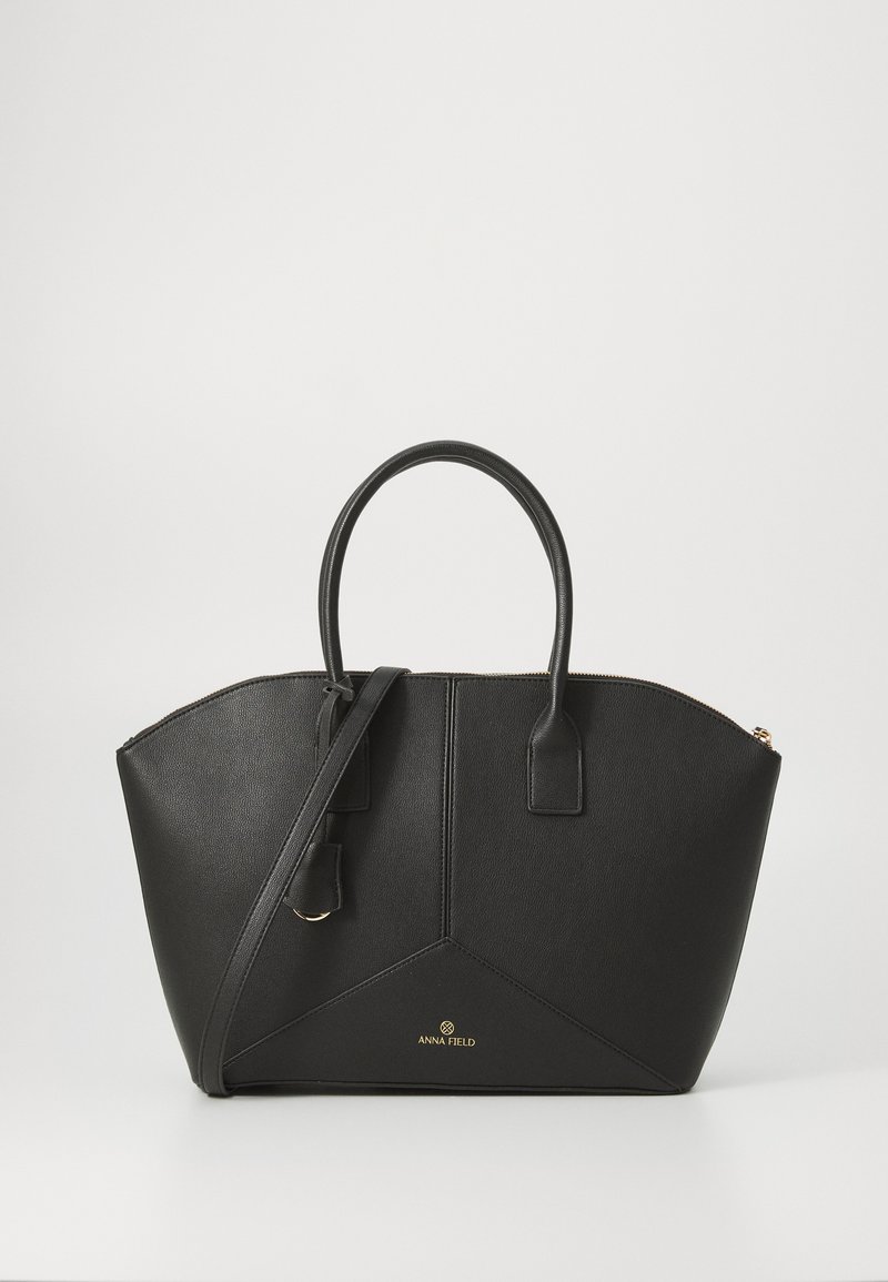 Black synthetic leather tote bag with dual handles and an adjustable shoulder strap. Features a geometric design and gold logo detail.