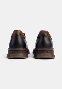 Smeđe kožne tenisice s teksturiranim završetkom, s podstavljenim ovratnikom i kontrastnim smešnim akcentima na peti i potplatu.