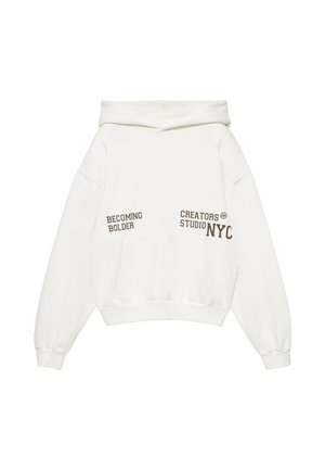 Hvid hættetrøje med frontlomme og brun tekst med teksten "BECOMING BOLDER" og "CREATORS STUDIO NYC" foran.
