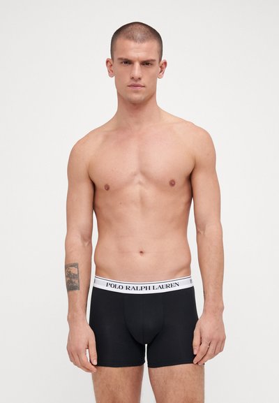 Boxeri negri cu talie albă ce au inscripționat textul "POLO RALPH LAUREN". Design simplu, textură netedă și formă ajustată.
