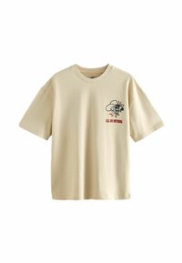 T-shirt en coton beige, coupe ample, avec un col rond. Présente un imprimé graphique d'un crâne portant un chapeau de cow-boy et le texte "TOUT OU RIEN".