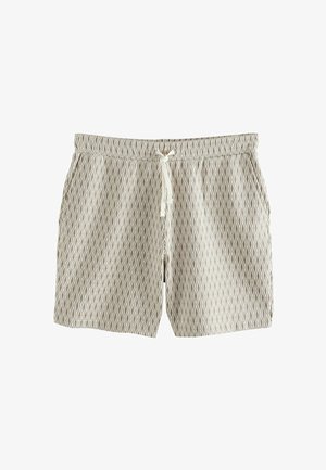 Shorts de bain à motif beige avec un design en losanges, fabriqués en tissu léger. Dotés d'une taille élastique et d'une fermeture à cordon.