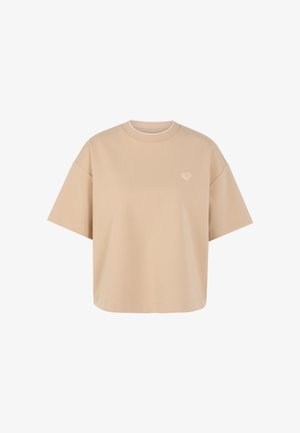 Beige oversized short-sleeve T-shirt with a small heart emblem on the left chest and a round neckline.