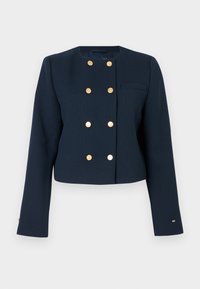 Marineblå cropped jakke laget av strukturert stoff, med gullfargede dobbeltknapper og en enkelt brystlomme.