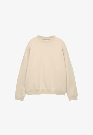 Crème-kleurig oversized sweatshirt met een ronde halslijn en geribbelde manchetten. Gemaakt van zacht materiaal met een gladde textuur en een minimalistisch ontwerp.