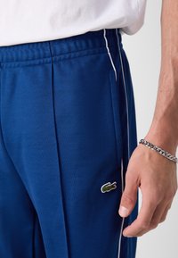 Lacoste Tepláky - globe