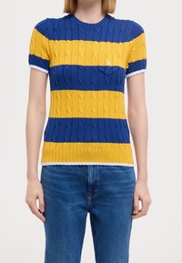 Knit short-sleeve sweater featuring blue and yellow horizontal stripes, cable patterns, and a white ribbed collar. Pocket on left chest.