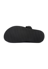 Calzature nere con suola testurizzata e scanalata. Design minimalista, forma piatta, senza chiusure visibili. Materiale morbido, adatto per l'abbigliamento casual.