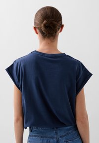 T-shirt blu navy a maniche corte con una vestibilità rilassata, scollatura rotonda e tessuto morbido. La vista posteriore mostra una texture liscia e una leggera caduta.