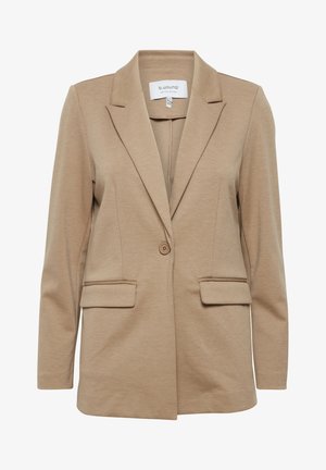 Beige blazer met een reverskraag en enkele knoopsluiting. Beschikt over twee voorzakken en lange mouwen. Glad, lichtgewicht stof.
