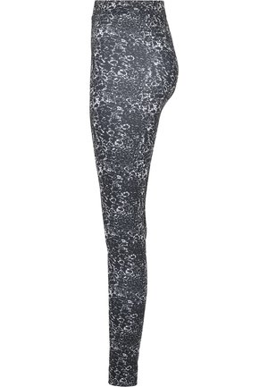 Black leggings with a white abstract pattern, fitted design, high waistband, and smooth texture. Features a full-length cut.