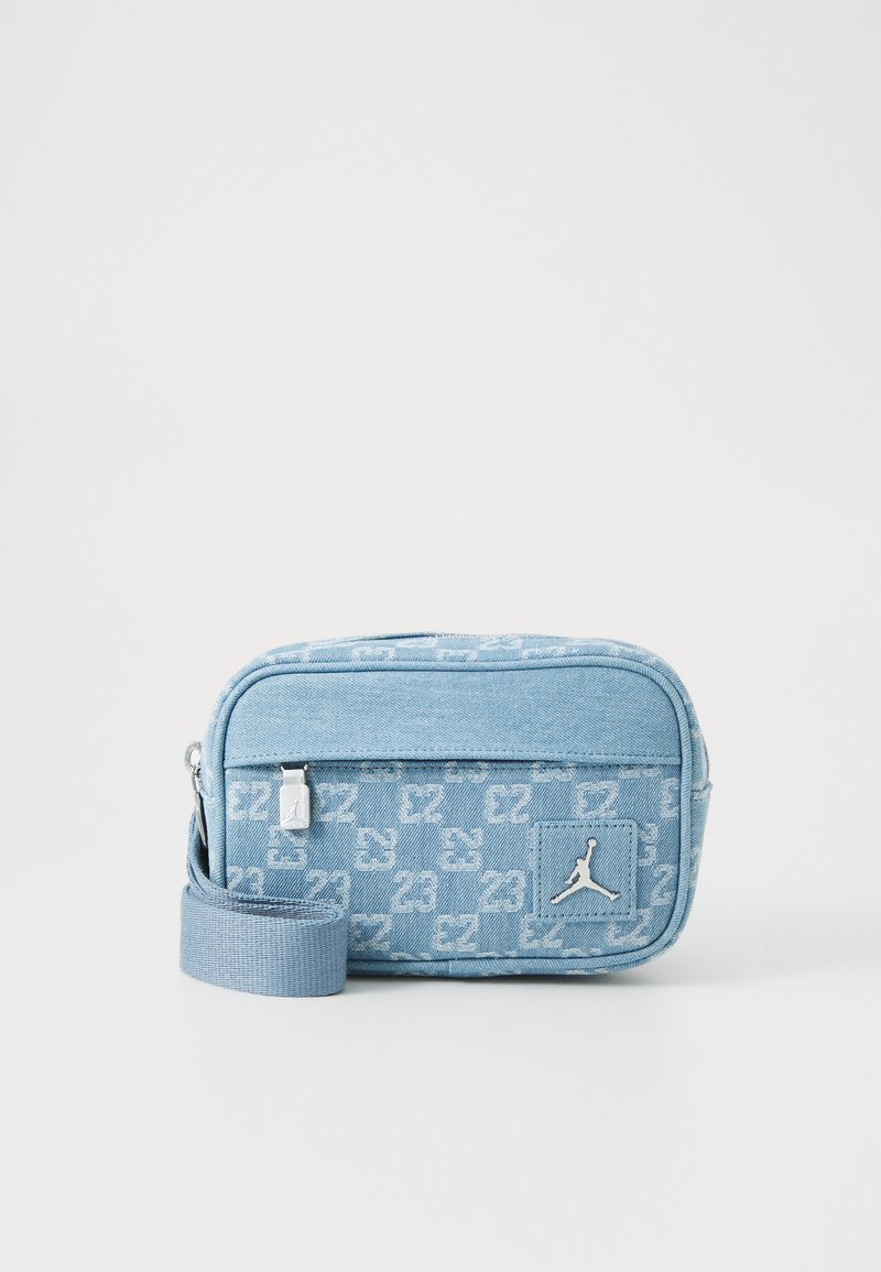 Blue denim crossbody bag with 23 logo pattern, zip closure, adjustable strap, and metallic hardware. Features a signature Jordan logo.
