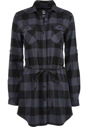 Chemise à carreaux noire et grise avec des manches longues, fermeture à boutons, deux poches poitrine et une taille avec cordon de serrage. Fabriquée dans un tissu doux avec une coupe décontractée.