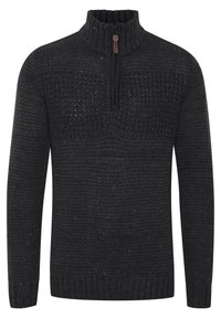 Suéter de punto gris oscuro con un cuello alto y una cremallera corta, que presenta un patrón texturizado y puntos multicolores dispersos por todo el tejido.