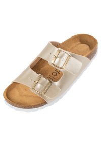 Light gold slide sandal featuring two adjustable straps with metallic buckles, cork footbed, and textured white outsole.